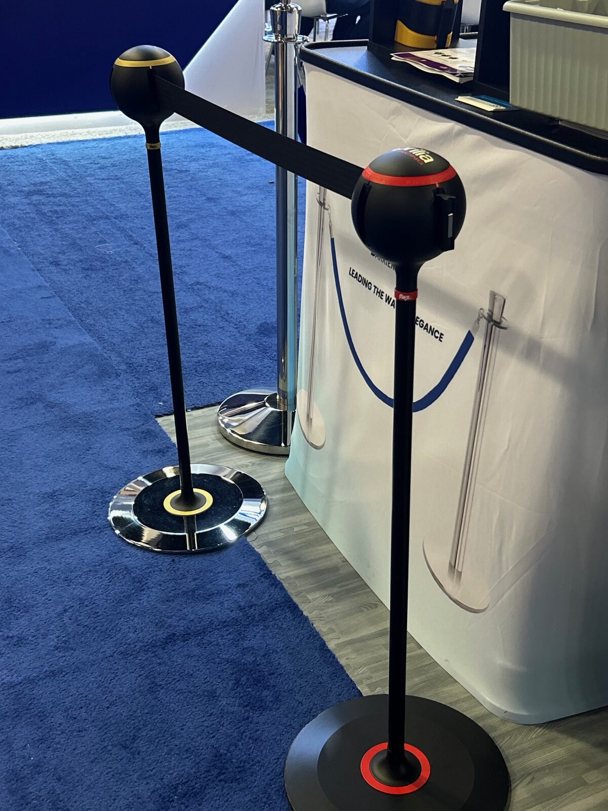 Custom ball top stanchions on display at a trade show booth