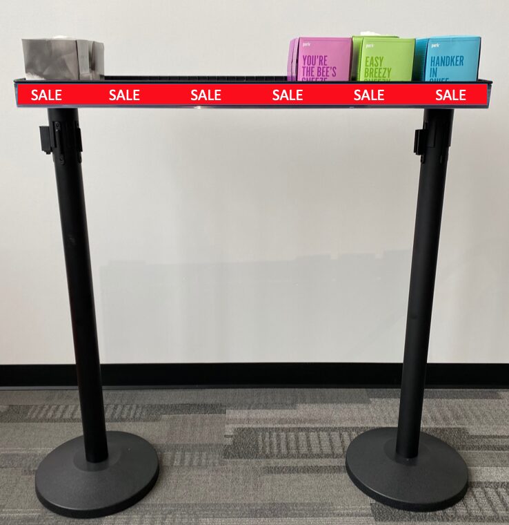 Impulse merchandising tray with price ticket strip on stanchion