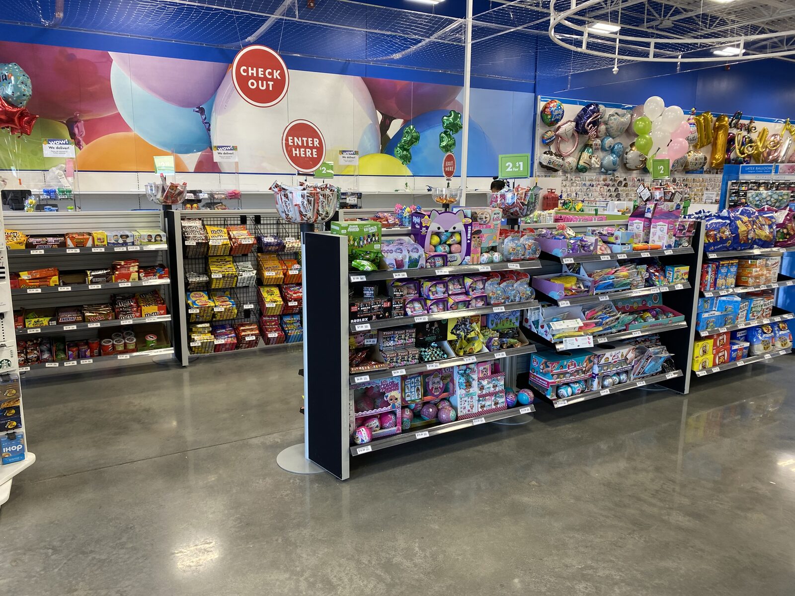 Candy display with Enter Here sign on stanchion queue