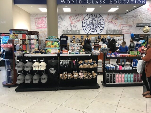 University bookstore checkout queue with impulse merchandise displays at Kean University